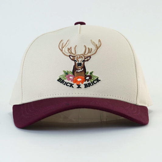 Cranberry Stag Cap, cream crown with maroon brim and embroidered stag